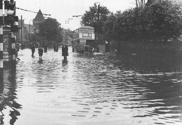The Hertford Road flooded by St Edmunds School in July 1956 - Lower Edmonton. The bus is probably an RT