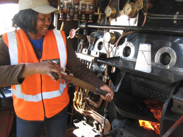 Many of the TFR staff climbed up on the footplate at Rayton and were very interested in the workings of a steam loco. Many commented on the historic value of it. This lady from TFR Infra wanted a turn at the shovel.