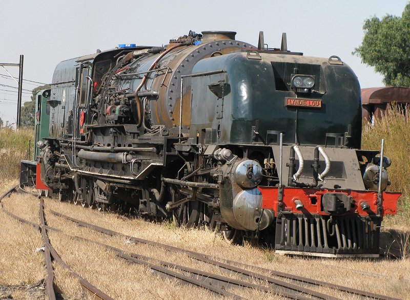 Dwarfing the small Hunslett, the Garratt is moved down the line to the points.