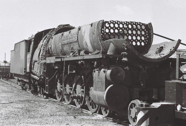 When locomotive scrapping first started, it  as tackled by the railways themselves, before such items were put on tender for scrapping. At Capital Park, there was a team of cutters that would tackle the locomotives within the depot confines. Here, a 15F is meeting its fate. The gutted boiler makes an interesting sight for those who are interested in the inner workings. The smokebox tubeplate end can be clearly seen.