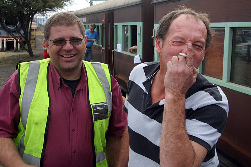 Smokers' forum. Gabor Kovacs and Les Weideman share a laugh and a smoke..
