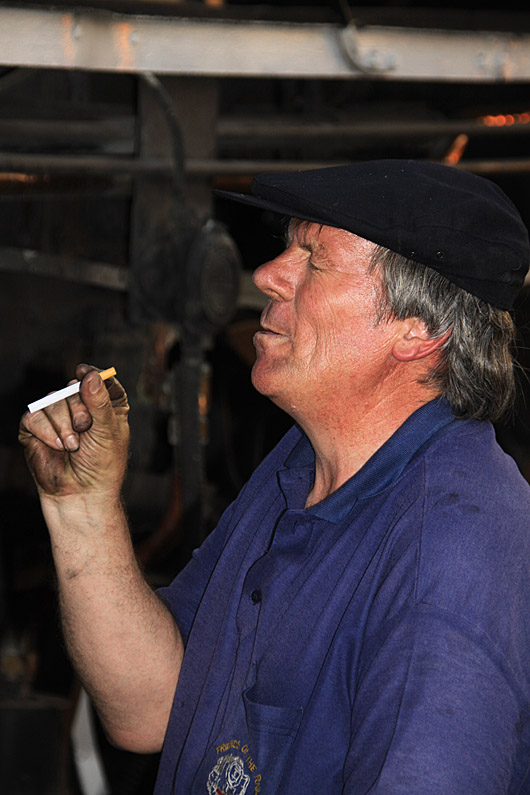 Now would you believe this one. Tony Attwell enjoys a satisfying drag after a long day on duty!