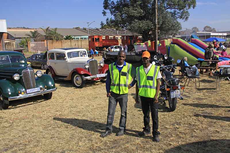 John Makopo and Raymond in front of the car display