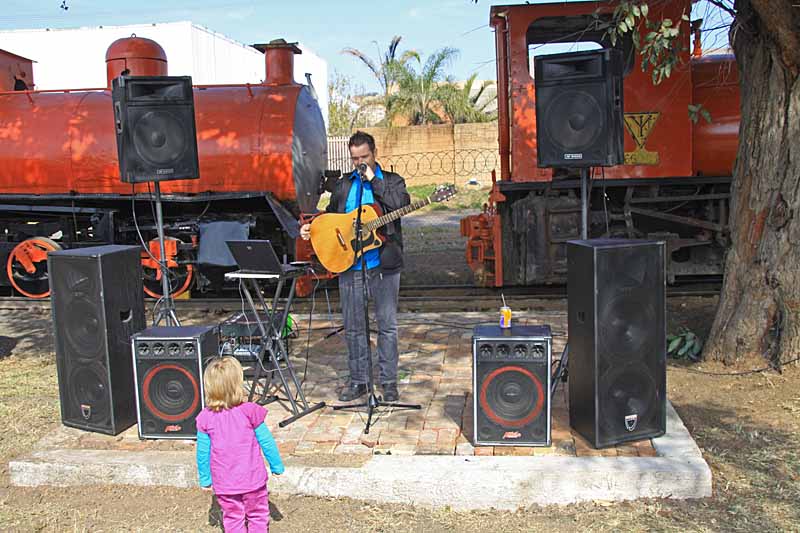 A stage was built by our site folk on Saturday to accommodate the musician, in front of the newly-painted fireless locos