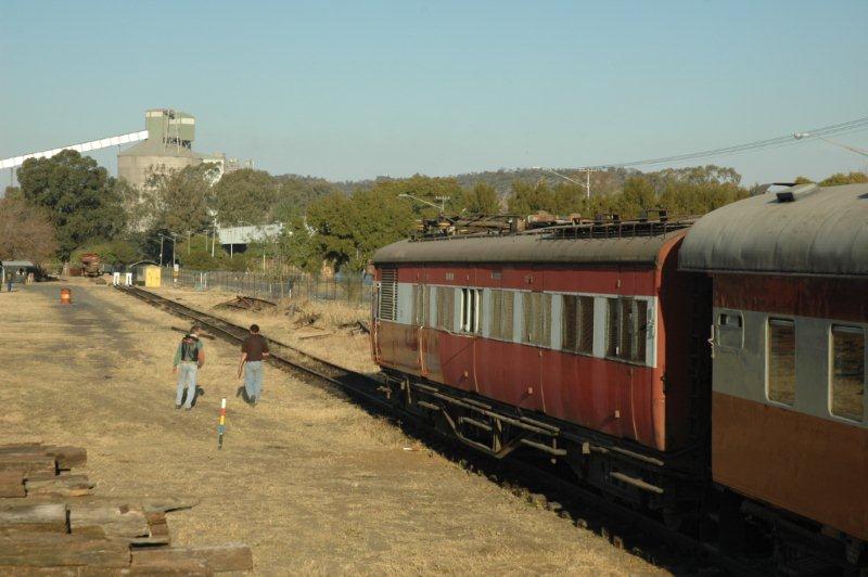 History being made. The first trial load consisting of an old motor coach driving unit, main line 2nd class sitter and our clerestory Manager's coach are the first to be placed. Arno Grundling does the shunt work with our security person, "Chopper", watching.