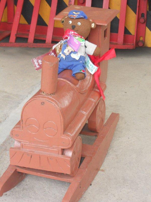 Having a seat on a wooden rocking train, Ted could not wait to get seated!