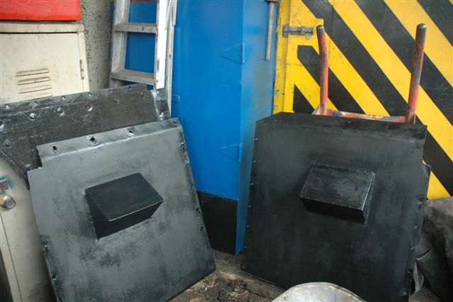 The valance plates, having been painted by Les and Nataniel, stand drying under cover, during the long rainy spell experienced.