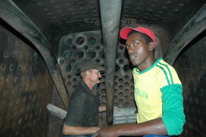 In the firebox of the class 19D, Spikkels and Lloyd are about to start building the firebrick arch