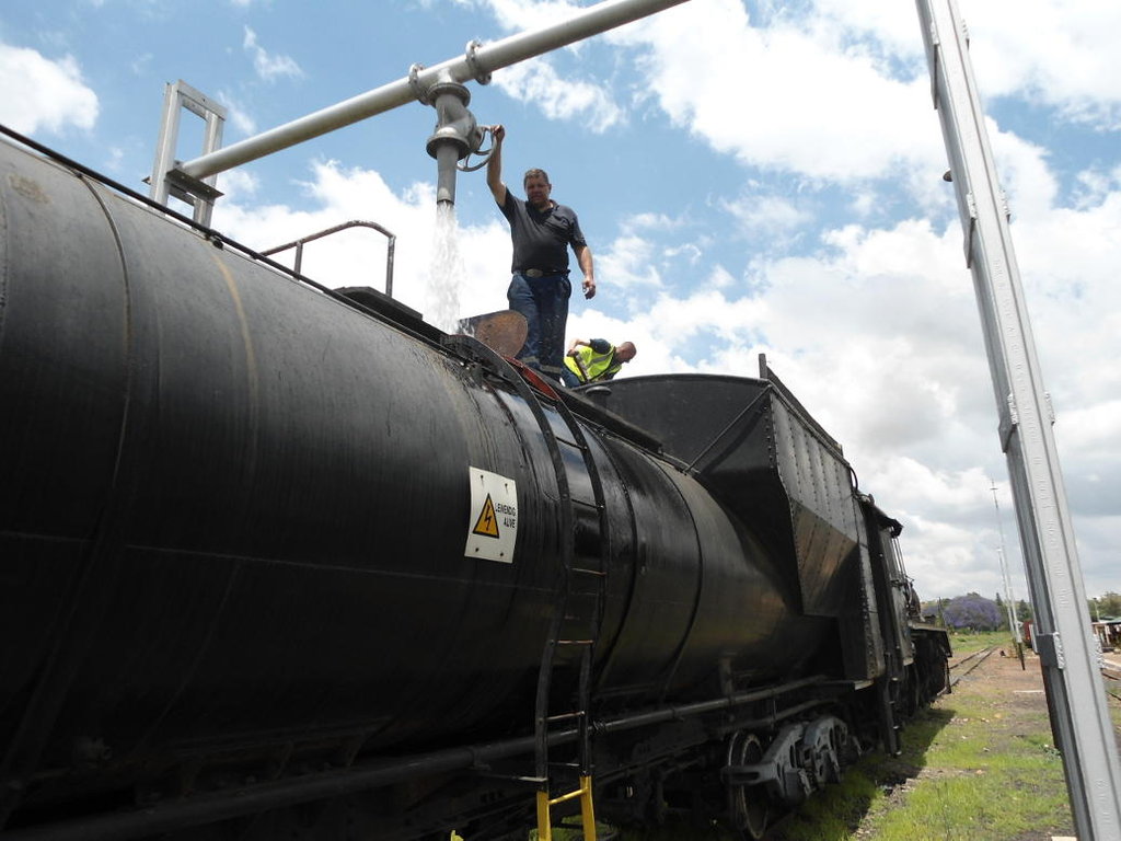 Gabor fills the water tank while Philip trims coal at Cullinan