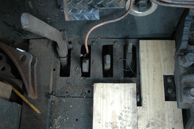 The floor boarding has had to be redone on the 15F. The previous attempt of bituminous treatment led to the wood warping and hence the new look. Steve Smith and Miemie were hard at work with the fitting. The viewoint is from the Fireman's side looking downwards. You will observe the pegs for the drop grate handle used to operate the grates. This locomotive is not fortunate in having steam shaker grates.