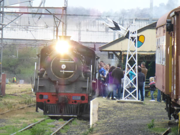 2650 stands at the head of the train as passengers mill around on the platform