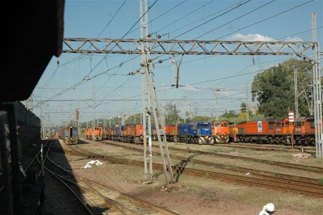 Motive power at rest. The silence of the Capital Park electric depot is broken by the passing of a steam loco, whilst a variety of 18E, 6E1, 8E and 34 class diesels look on