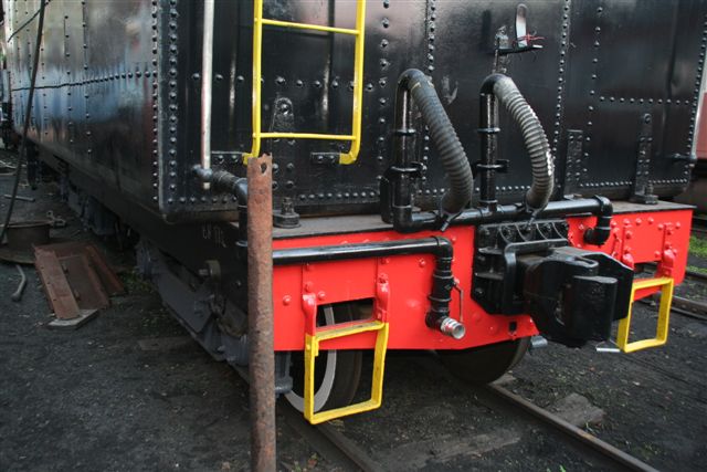 Rusty pipe removed and standing next to tender of 3117