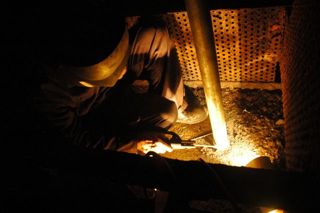 Deep in the bowels of the tender of 15F 3117, John Dadford is putting the final touches to the welds on the replacement piping for the vacuum pipe channel. The 15F has the vacuum reservoir mounted on the flat portion of the tender rear and the pipe work is fed through the water space to below the tender where it then carries on its journey on the surface. The new galvanised pipe is the protective housing for the vacuum pipe. Note the perforated baffle plates to break the movement of the water whilst the locomotive is in operation.