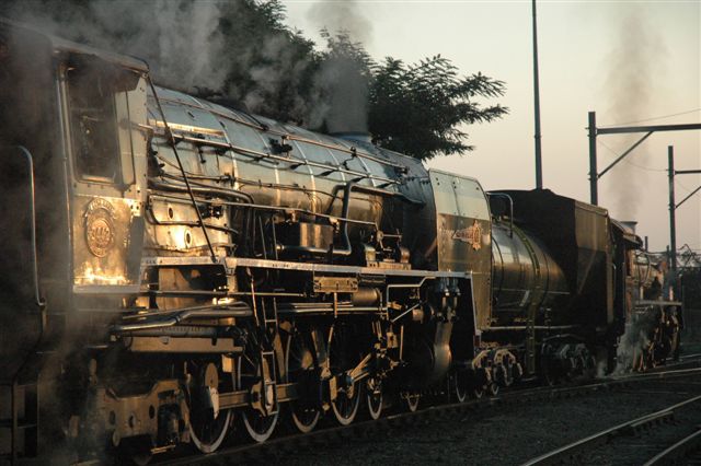 Spot the difference. Easy, the front locomotive is ....hand fired! 3360 and 3442 ready to roll on a Rovos charter train. The huge form of the 25 class bunching up against the little "Dolly" outlined by the late afternoon winter sun