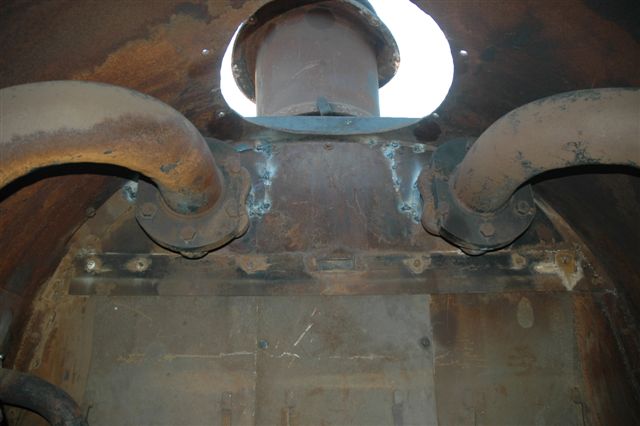 The empty smokebox chamber of 3117. There were a number of places where gaps had to be closed up by welding metal strips in place to prevent sparks from being emitted, and thus preventing line side fires. To affect the repair, the complete petticoat and chimney had to be removed. Work was also carried out on the left side branch steam pipe