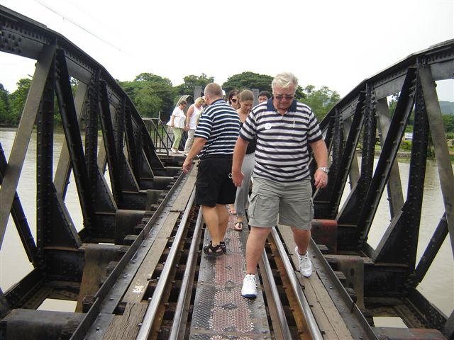 Tourists walk across the famous bridge. There is also a train service run by diesels. However, in November, every year, there is a steam train service operating with two C56 class locos based in Thonburi depot, Bangkok.