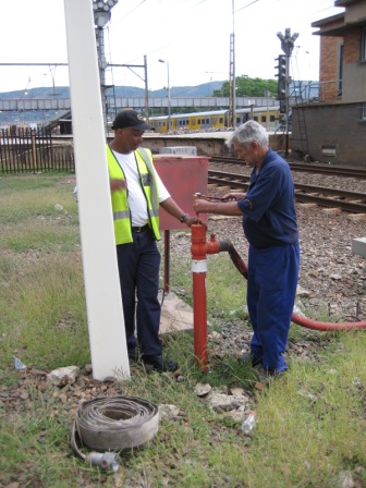 Johns D and M open the hydrant using ingenuity as we didn't have the correct tool