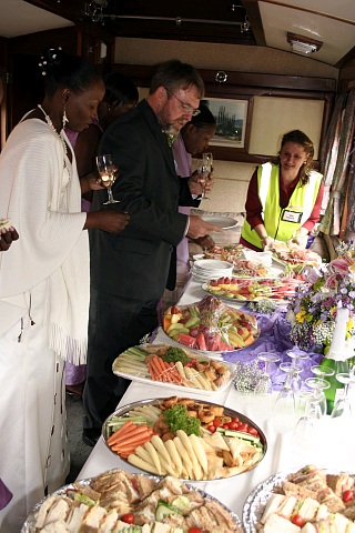 Train Manager Bev unwraps the food in the Regional Manager's Saloon