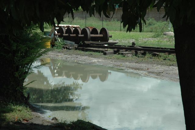 A tranquil afternoon on the shores of Lake Hermanstad. The soft reflection of rusty wheels in murky waters. Just the buzzing of the flies, breaks the<br />otherwise quiet Sunday